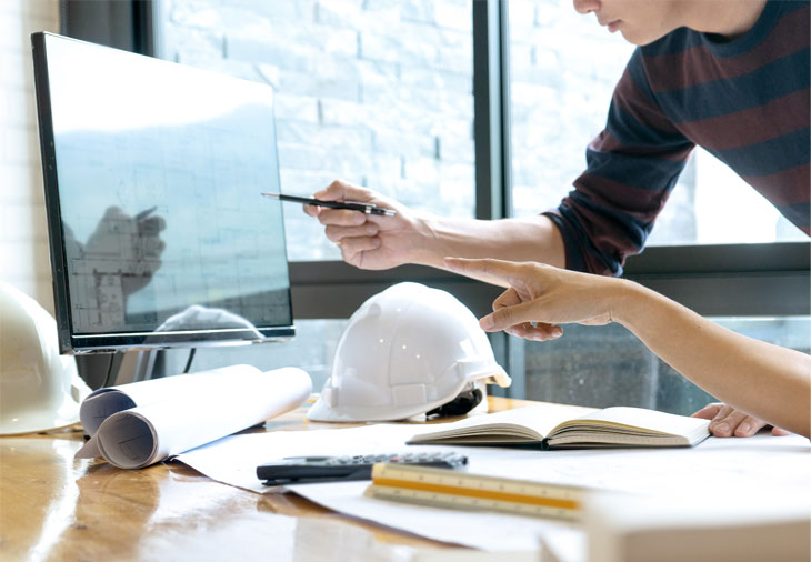 Larkin Hathaway project team reviewing CAD drawings on a computer screen